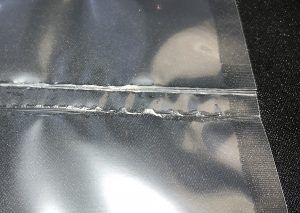 Low pressure vacuum packaging seal