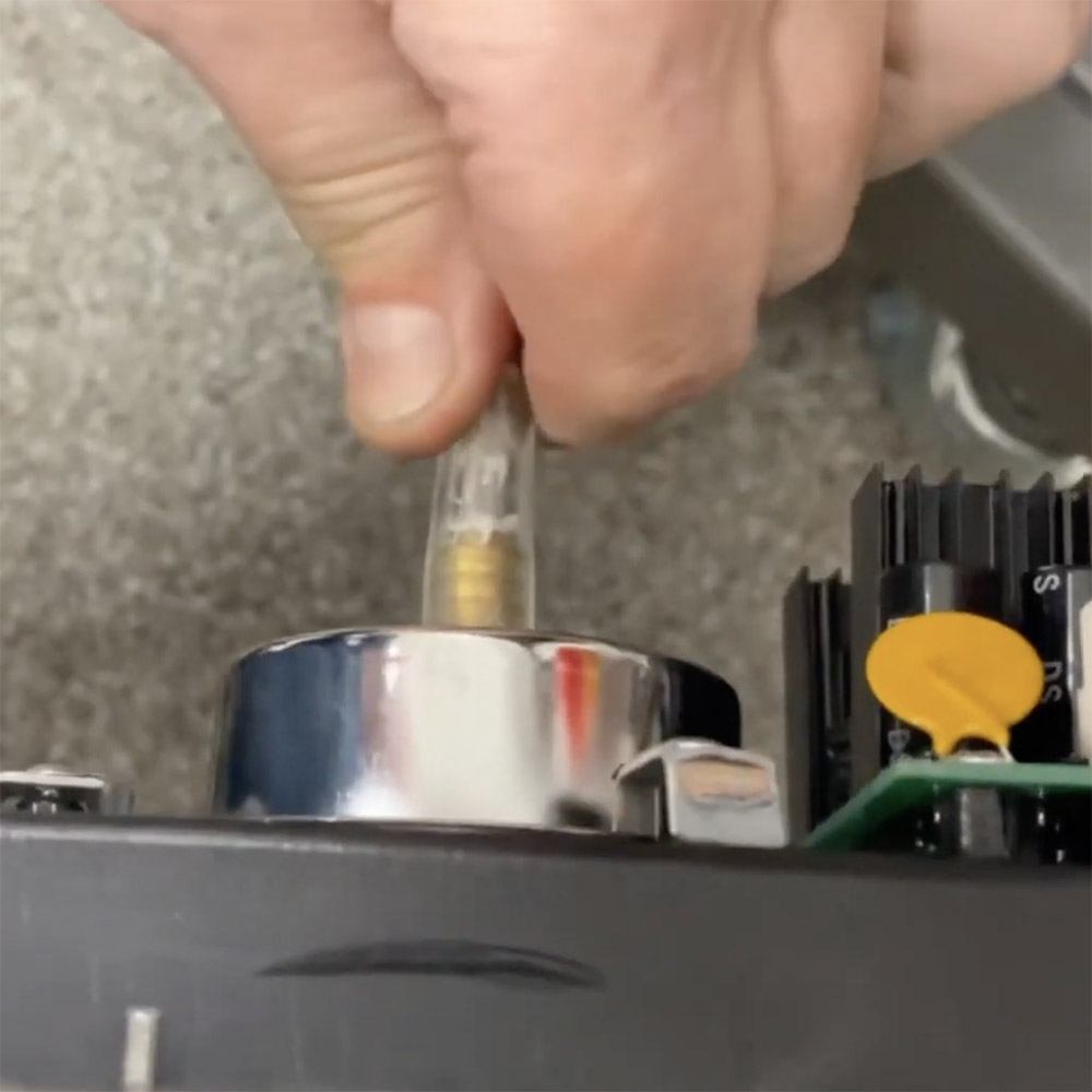 Disconnecting vacuum hose from front panel of Vac610